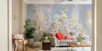 Ethereal Blossom Photography soft white floral wall mural behind a gray sofa with pink and red pillows in a living room