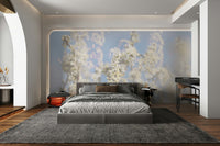 Ethereal Blossom Photography soft white floral wall mural behind a gray bed with a black desk in a modern bedroom