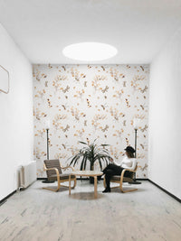An angled shot of a wall with floral and insect wallpaper

