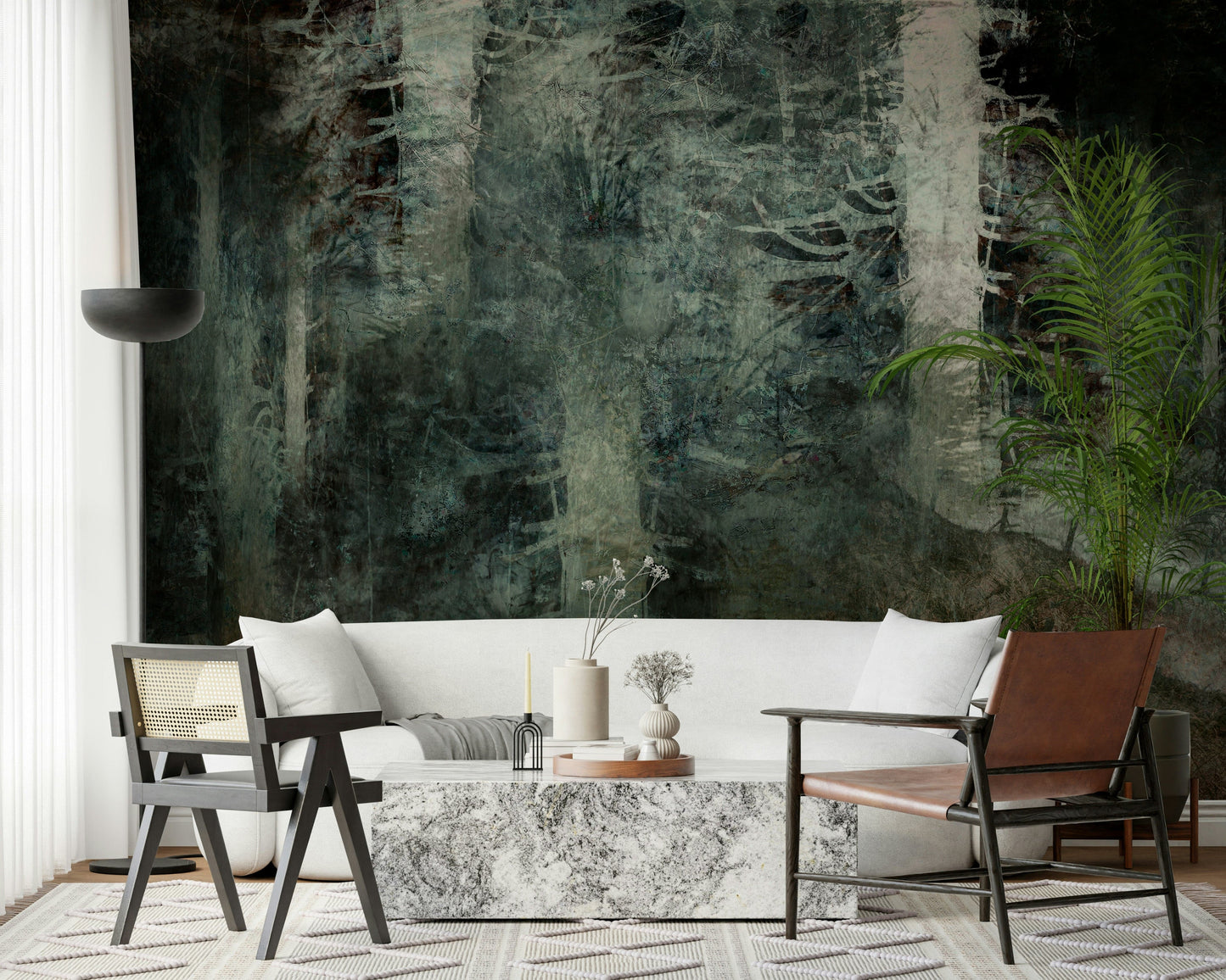 Ethereal Forest Dream wallpaper mural of moody forest behind a white sofa, leather sling chair and marble table