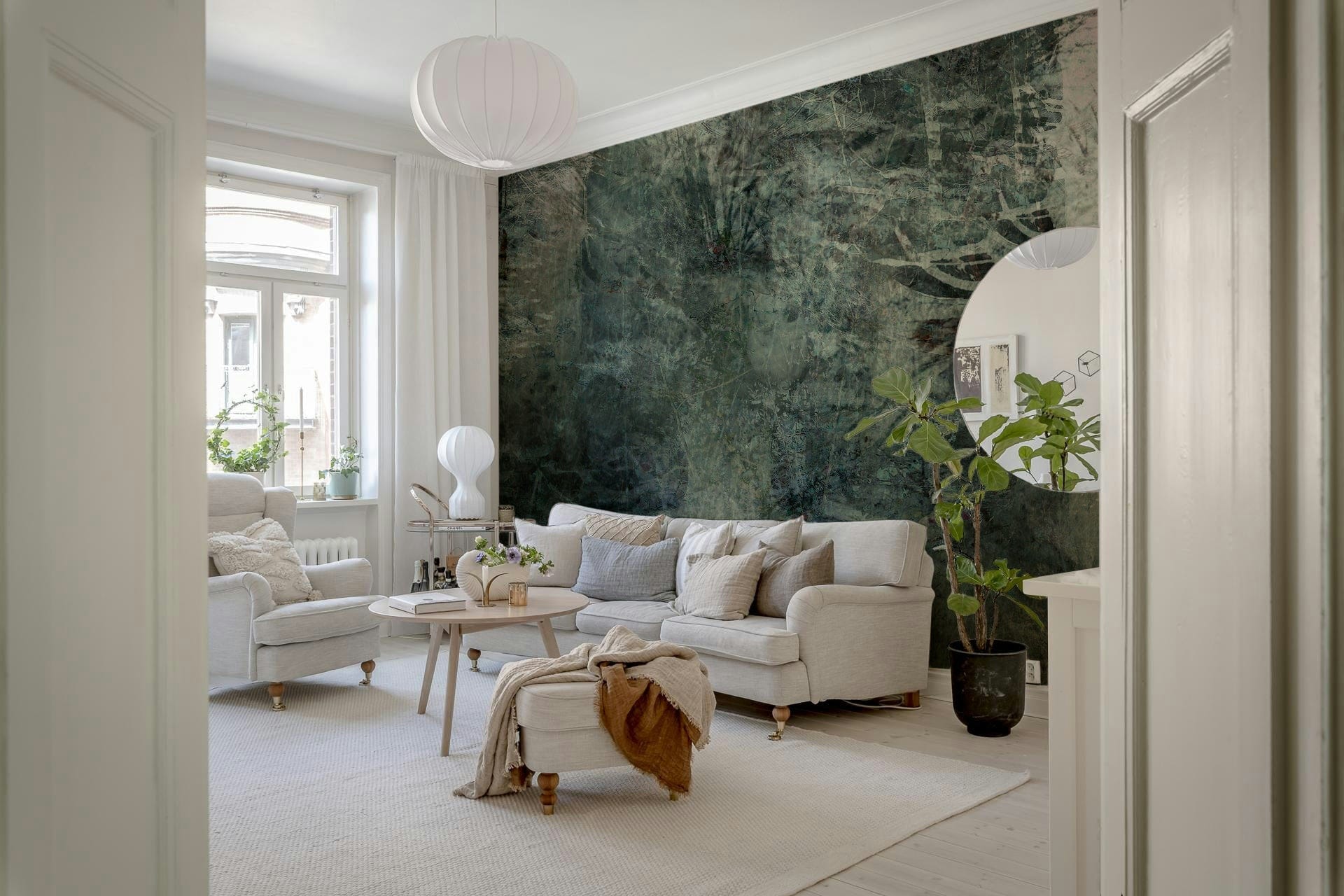 Ethereal Forest Dream wallpaper mural of green woodland behind a white rolled-arm sofa and fiddle-leaf plant