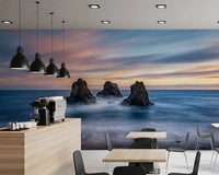 Ocean rocks wall mural adds a room accent with misty waves and sunset tones