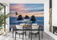 Coastal wall mural with ocean rocks, for a dining room, under a pastel sunset sky