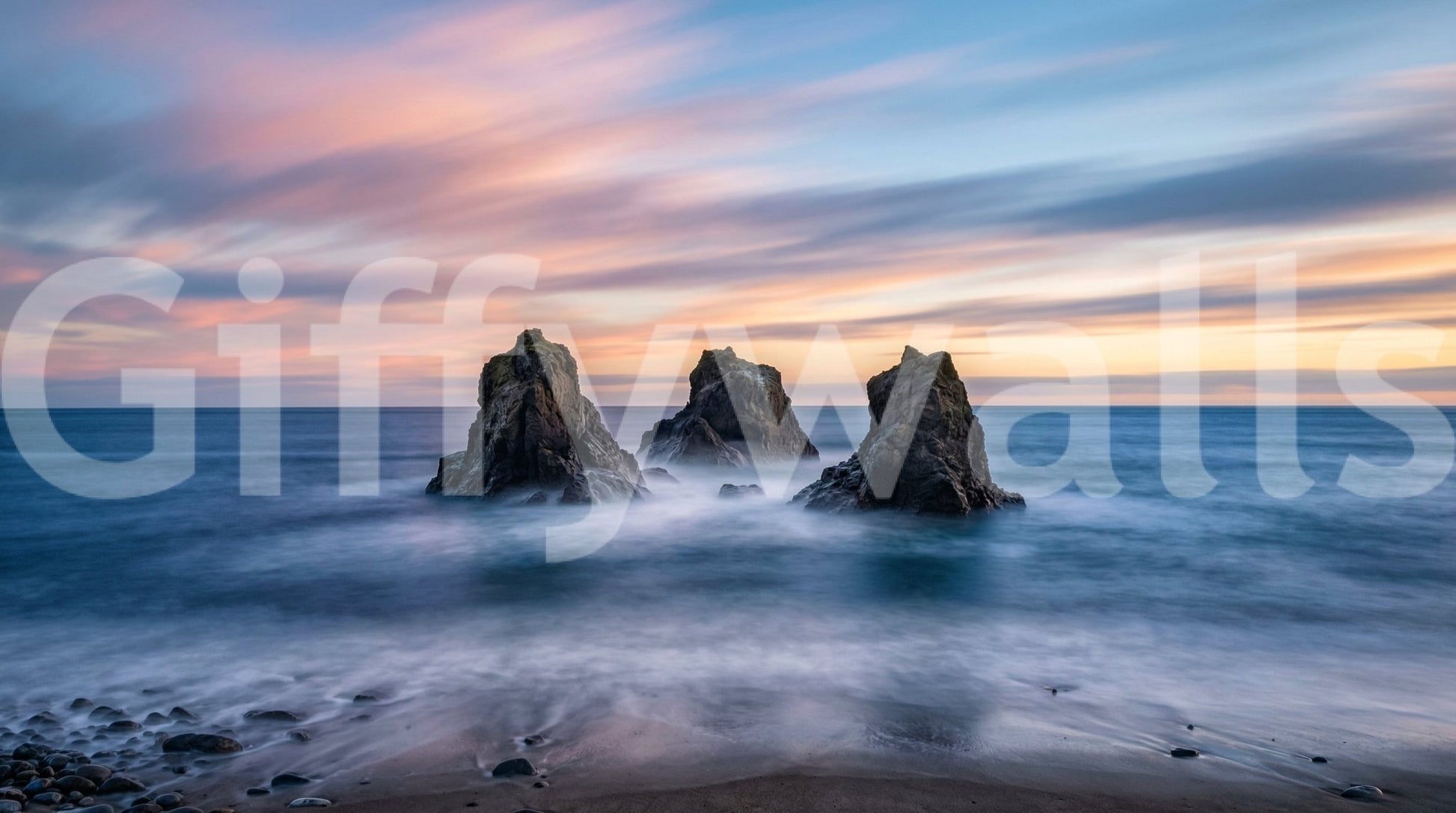 Ocean sunset wall mural with flowing water and rugged coastal rocks