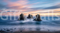 Ocean sunset wall mural with flowing water and rugged coastal rocks