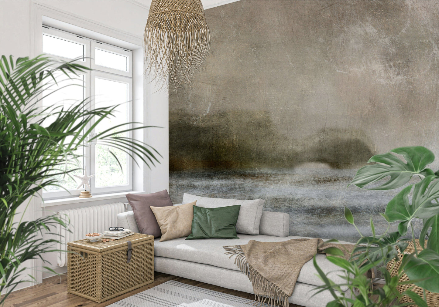 Ethereal Shoreline wallpaper mural, misty taupe horizon landscape on a wall behind a grey sofa and leafy plants
