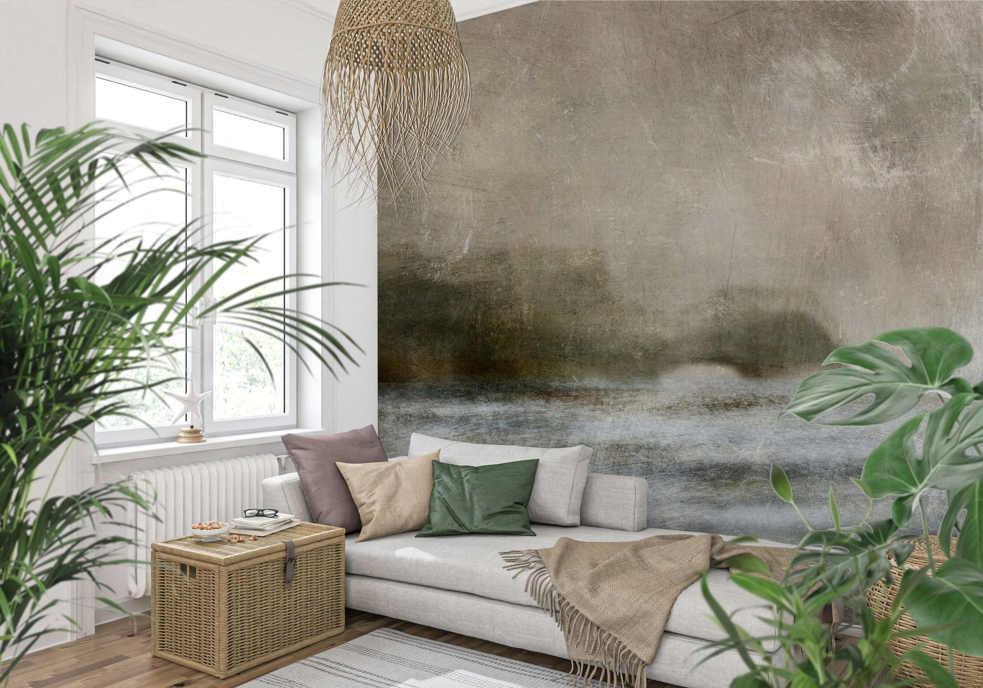 Ethereal Shoreline wallpaper mural, misty taupe horizon landscape on a wall behind a grey sofa and leafy plants