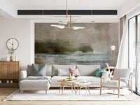 Ethereal Shoreline wallpaper mural in a living room, soft grey-and-taupe seascape behind an L-shaped sofa