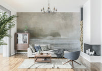 Ethereal Shoreline wallpaper mural on a grey living room wall with chandelier, beige sofa and wood cabinet