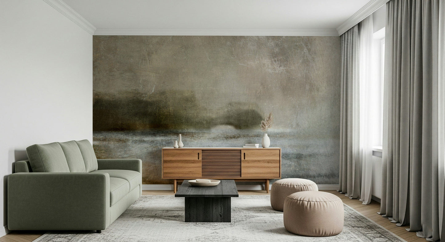 Ethereal Shoreline wallpaper mural on a wall behind a green sofa, wood sideboard and beige poufs in a living room