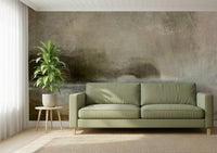 Ethereal Shoreline wallpaper mural, muted misty landscape on a wall behind a sage green sofa and potted plant