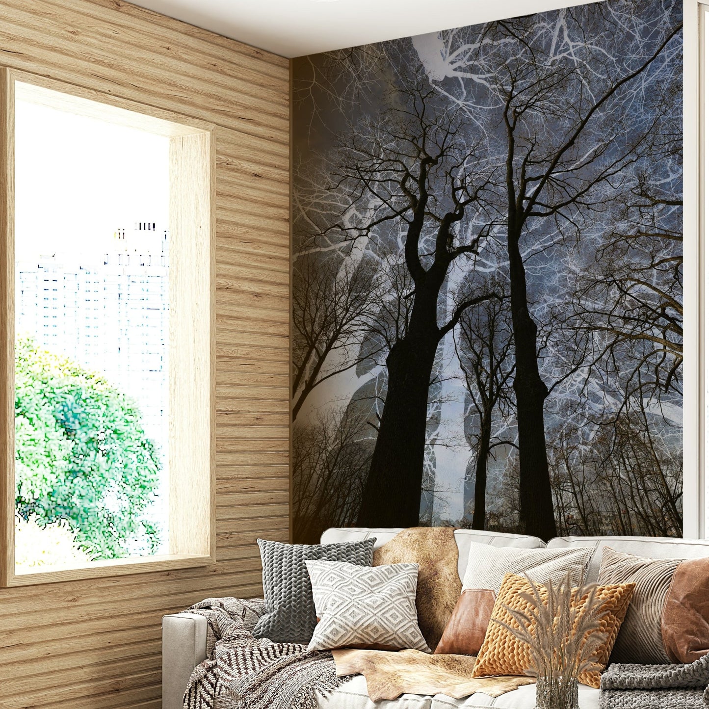 Ethereal Tree Silhouette wall mural of black trees on a moody sky in a living room corner with mixed pillows