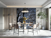 Ethereal Tree Silhouette wall mural of bare trees behind a round dining table with tan chairs and a pendant lamp
