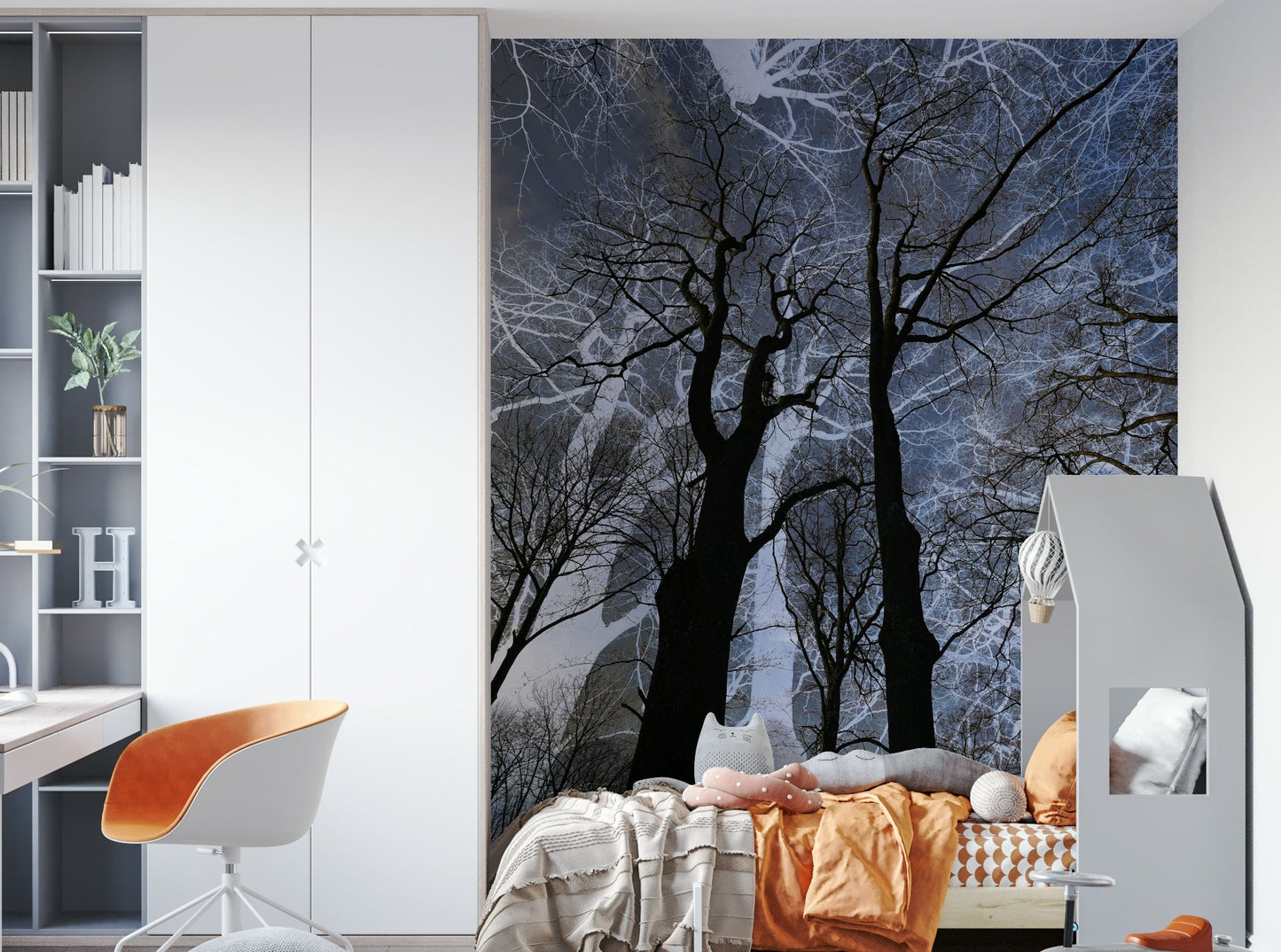 Ethereal Tree Silhouette wall mural of trees on a blue sky in a kids room with orange bedding and a desk