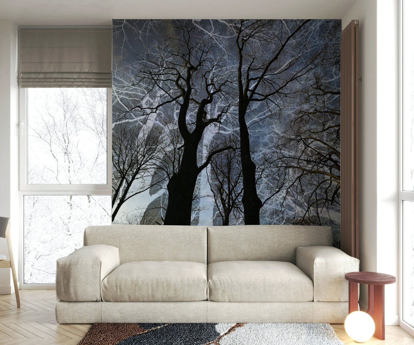 Ethereal Tree Silhouette wall mural of trees against a grey sky behind a linen sofa with a red side table