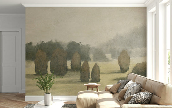 Ethereal Valley wallpaper mural of a misty tree-lined meadow on a wall behind a tan sectional sofa in a living room