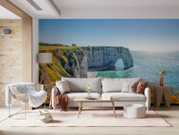 Etretat cliff arches wall mural with yellow blooms, green color shades and sea wallpaper waterline