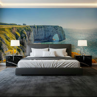 Scenic Etretat wall mural with yellow blooms and greenery, green color + ocean wallpaper coastal view