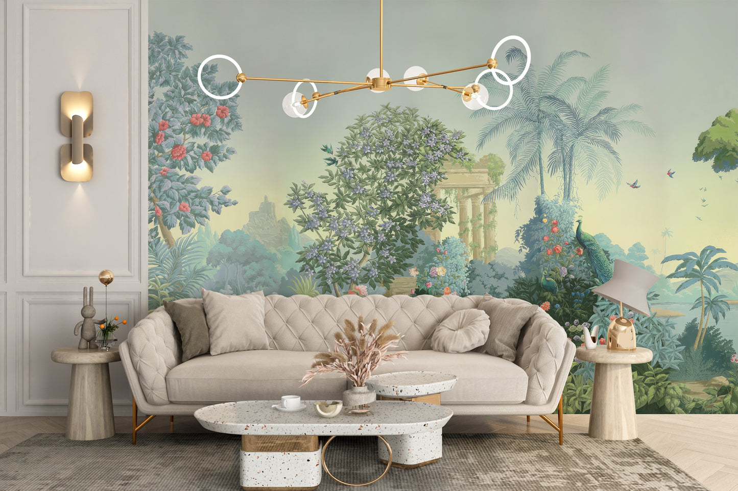 Exotic Paradise wallpaper mural of lush palms and peacocks in sage green behind a tufted cream sofa and terrazzo coffee table