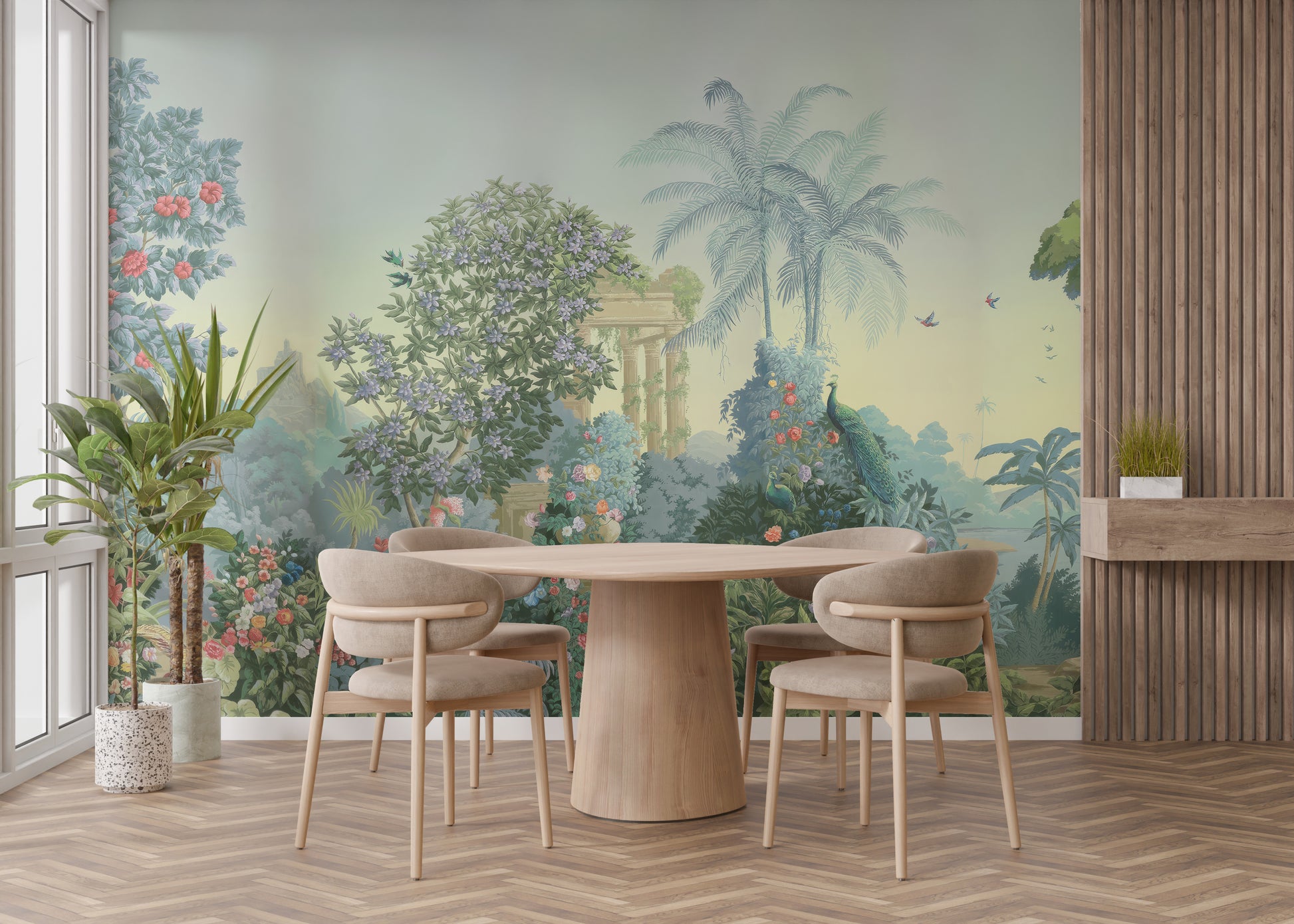 Exotic Paradise wallpaper mural with palms, peacocks and classical ruins in sage green behind a round wood dining table and beige chairs