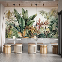 Exotic Greenery wallpaper mural of lush leaves in a dining area with white tables and rattan stools