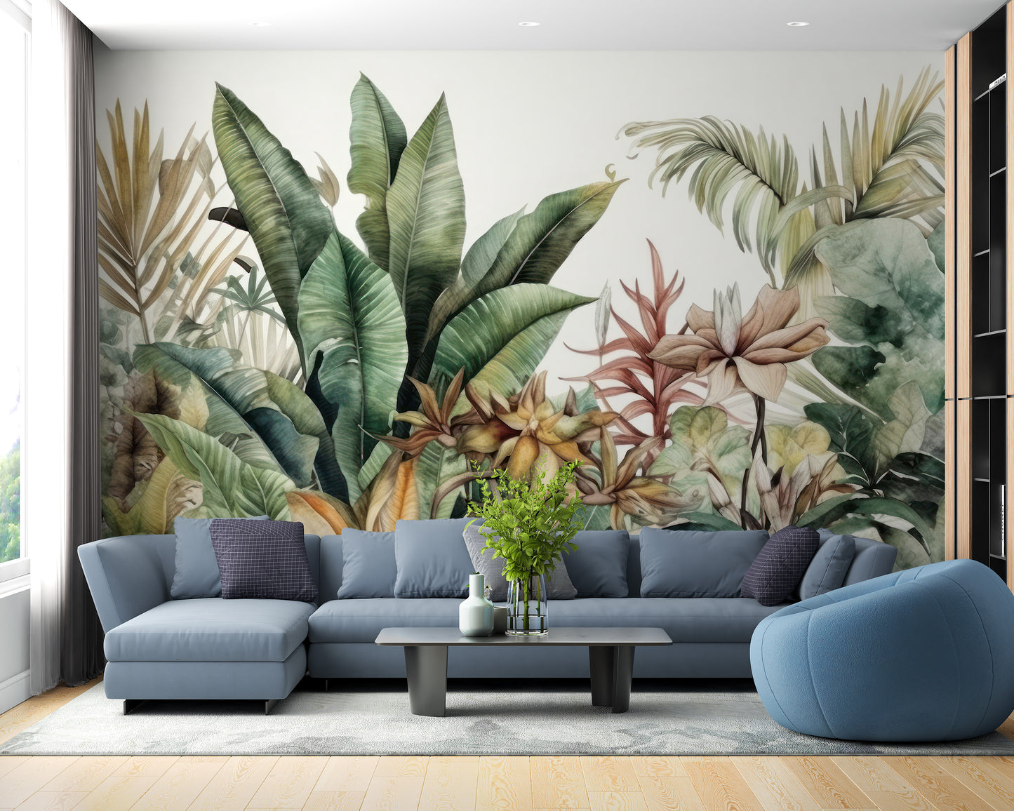 Exotic Greenery wallpaper mural with tropical leaves and blush flowers behind a blue sectional sofa