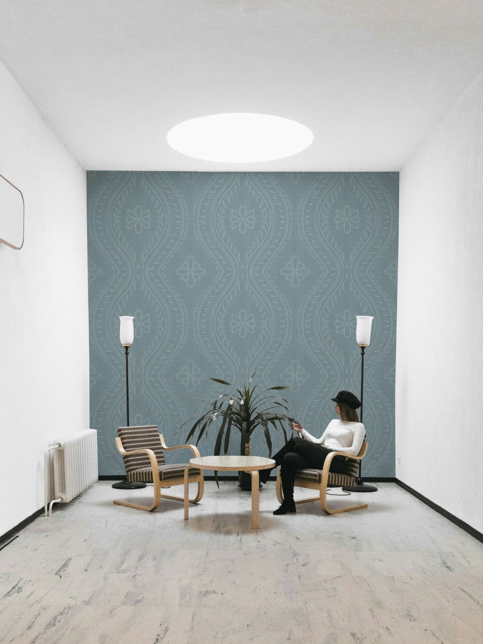 Calm interior with faded damask blue wallpaper

