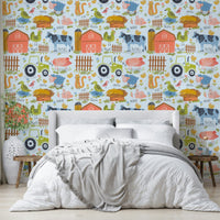 Farm Friends Fun wallpaper on a blue background behind a white bed with a grey throw in a bedroom