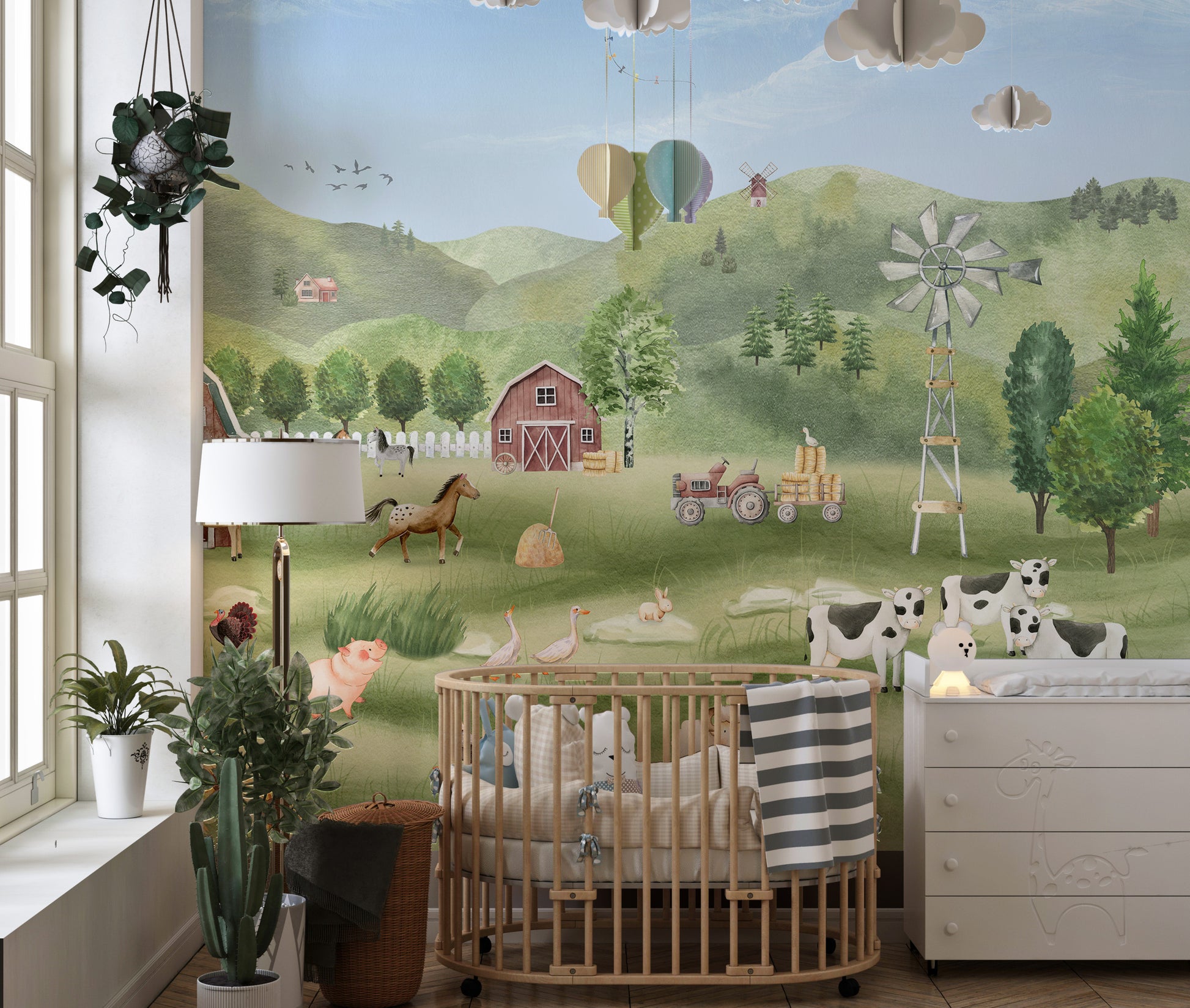 Farm Animals wallpaper with barn, horses, cows and hot-air balloons behind a round wooden crib in a nursery