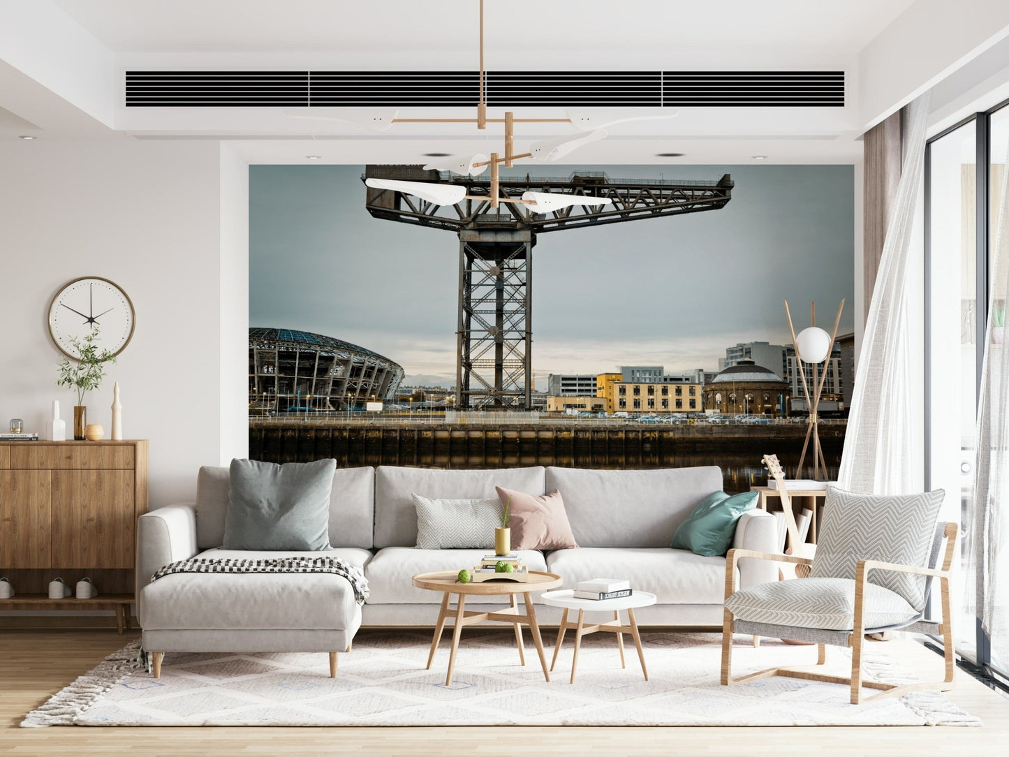 Finnieston Crane wall mural of the Clydeport crane behind a cream sectional sofa under a sculptural chandelier