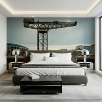 Finnieston Crane wall mural of the Glasgow waterfront above a gray bed with mirrored nightstands and lamps