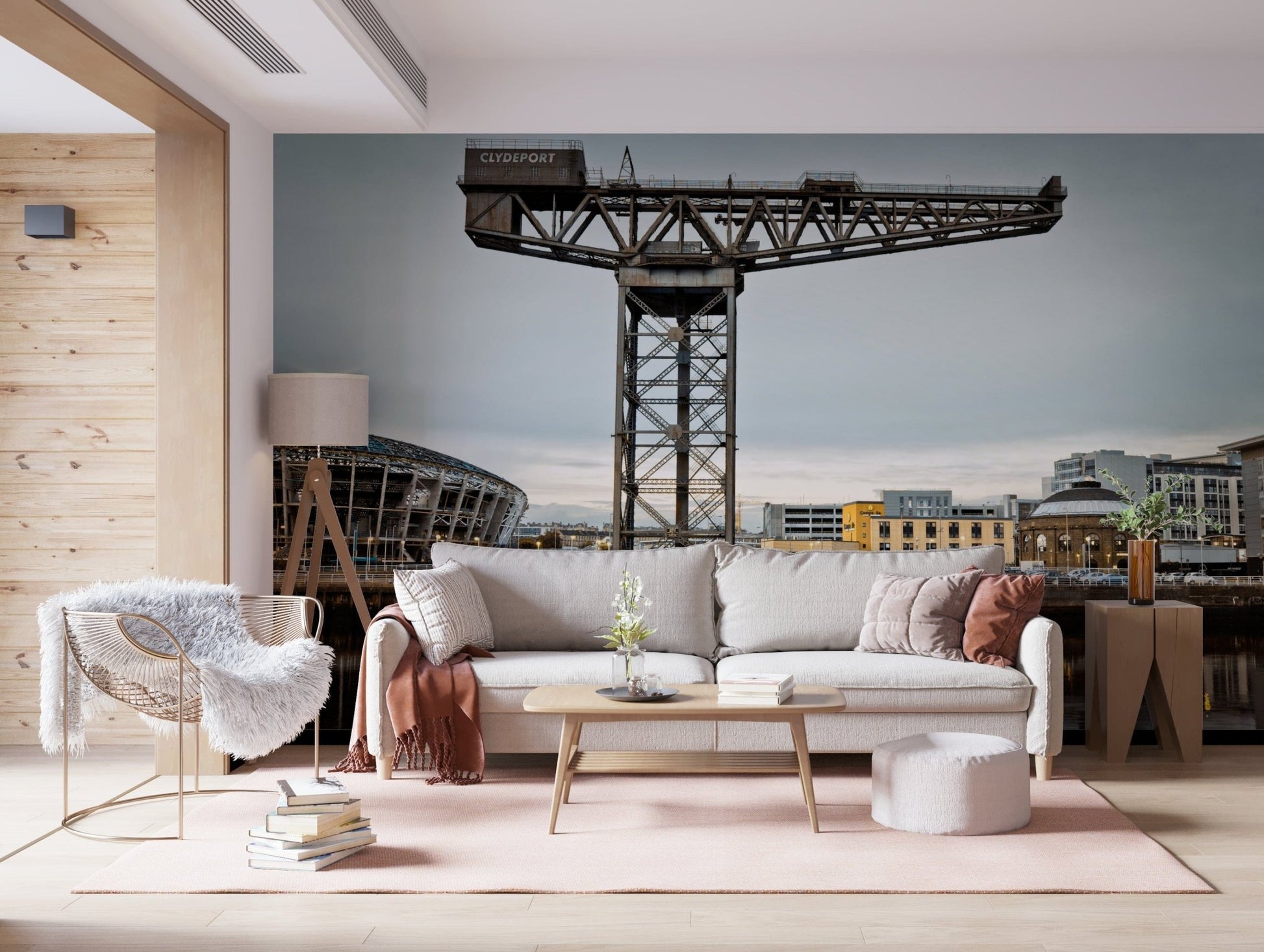 Finnieston Crane wall mural of the Clydeport crane behind a cream sofa and woven accent chair in a living room