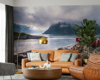 Wall mural depicting a peaceful Norwegian fjord with rocky terrain and fog drifting over mountain tops.