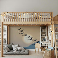 Wall mural with flamingos flying gracefully under a glowing evening sky.