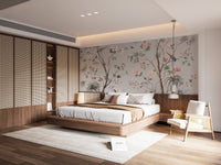 Chinoeserie Floral design wallpaper mural in soft gray behind a low wood platform bed with cane headboard in a bedroom