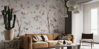 Chinoeserie Floral design wallpaper mural with pink peonies and birds behind a camel sofa and cactus in a living room