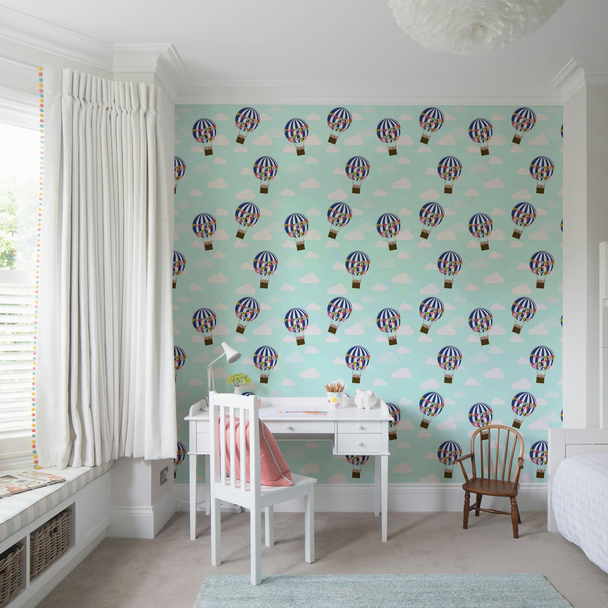 Floral Hot Air Balloons wallpaper in a kids study corner with a white desk, pink chair and window seat