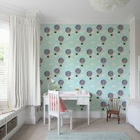 Floral Hot Air Balloons wallpaper in a kids study corner with a white desk, pink chair and window seat