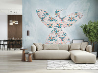Floral Hummingbird wall mural in teal and coral on blue behind a beige sectional sofa in a living room