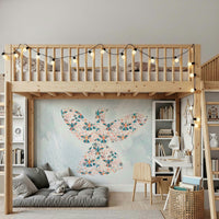 Floral Hummingbird wall mural in coral and teal under a wood loft bed with string lights in a kids room