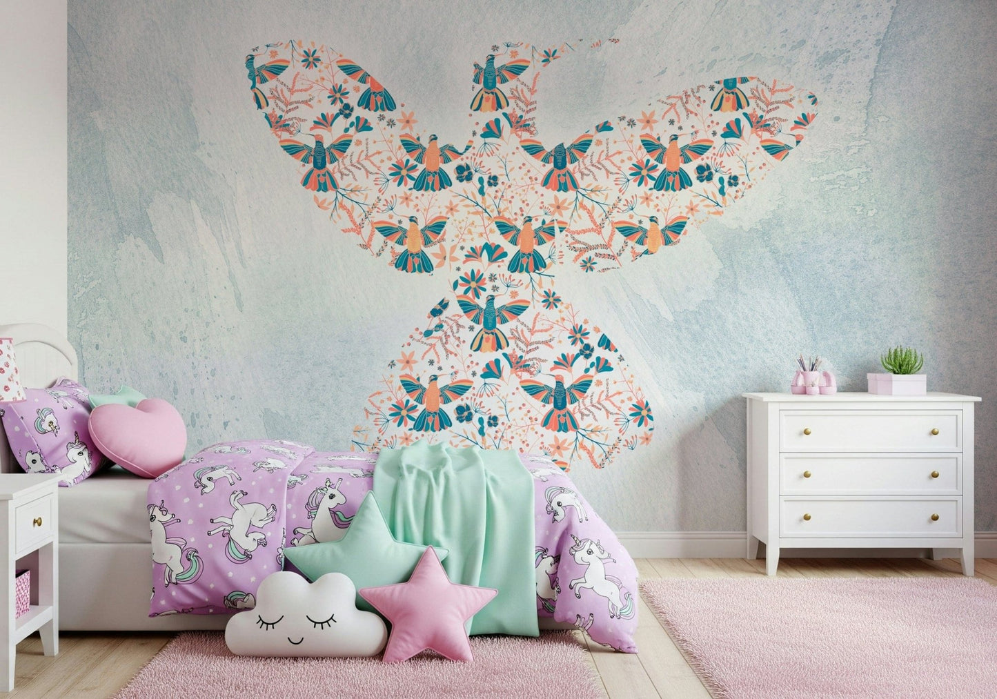 Floral Hummingbird wall mural on pale blue behind purple unicorn bedding in a girls bedroom