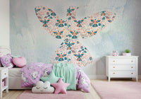 Floral Hummingbird wall mural on pale blue behind purple unicorn bedding in a girls bedroom