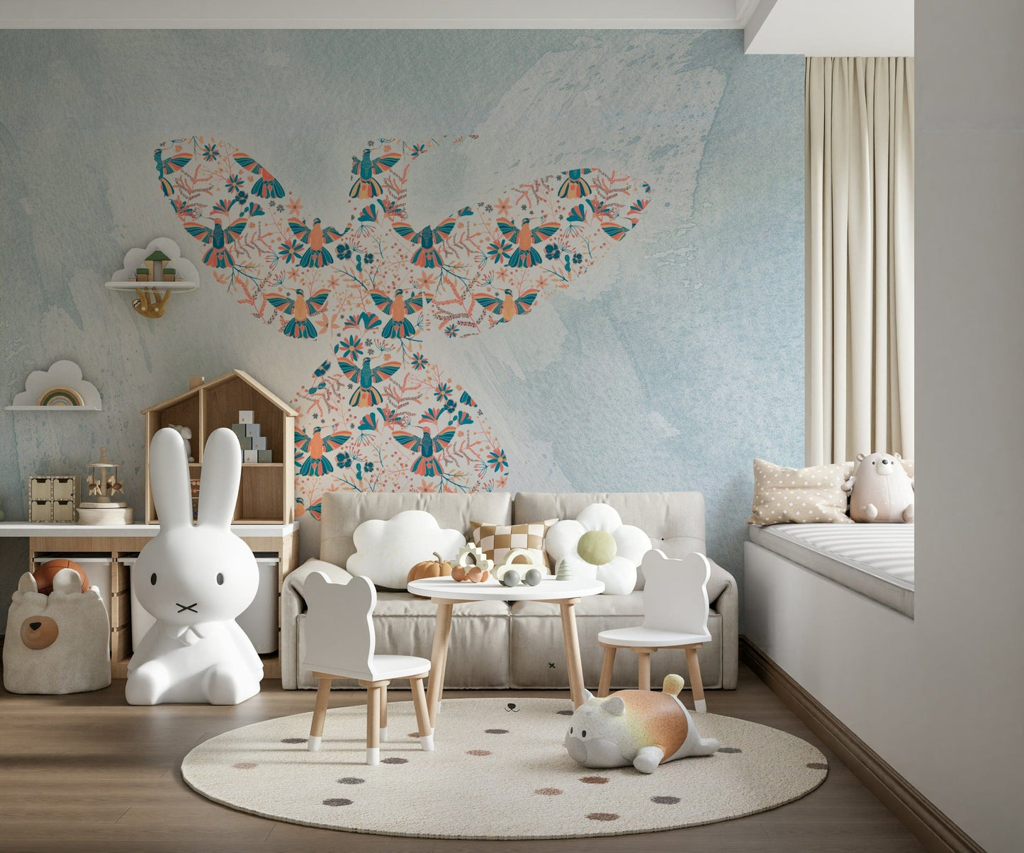 Floral Hummingbird wall mural of a bird shape on blue above a sofa and kids table in a playroom