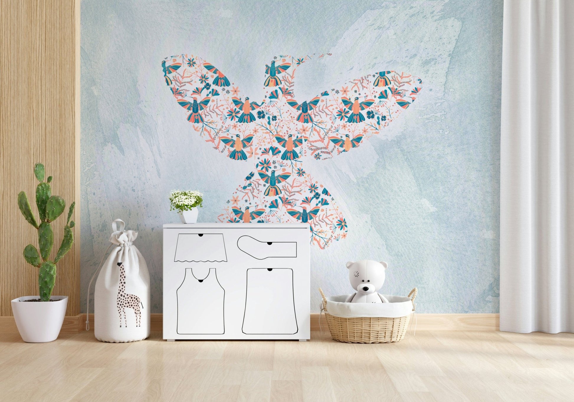 Floral Hummingbird wall mural of a bird shape on blue above a white dresser and cactus in a nursery