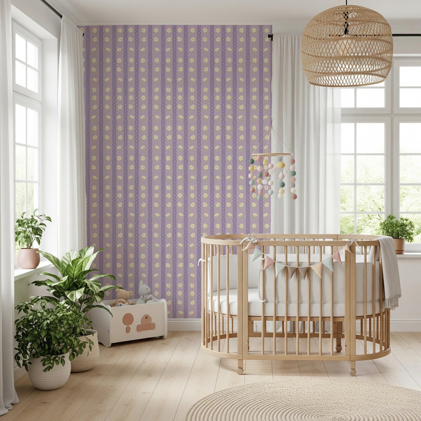 Floral Lavender Stripe wallpaper mural in a nursery behind a wood crib with pompom mobile and leafy plants