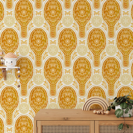 Floral Rockets Golden Yellow wallpaper, ornate gold medallions above a rattan cabinet in a kids room