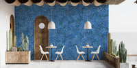 Flower Pattern Embroidery Blue wallpaper mural on a cafe wall with white chairs, cactus planters and a wood arch door