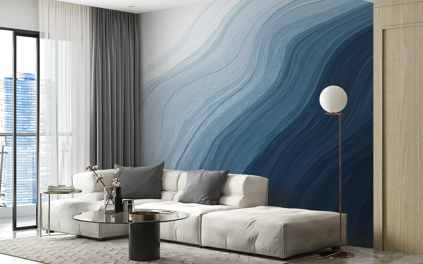 Fluid Blue Gradient Watercolor wallpaper mural behind a cream sectional sofa and globe floor lamp in a living room