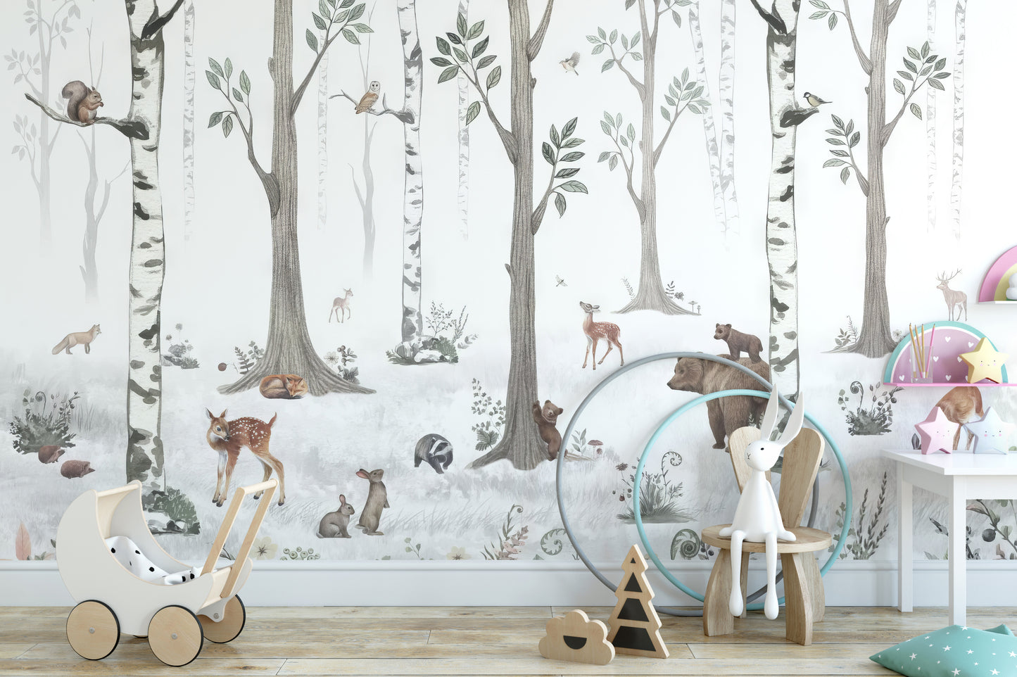 Forest Haven wallpaper mural of birch trees with fox and rabbits behind a toy pram and wooden chair in a kids room