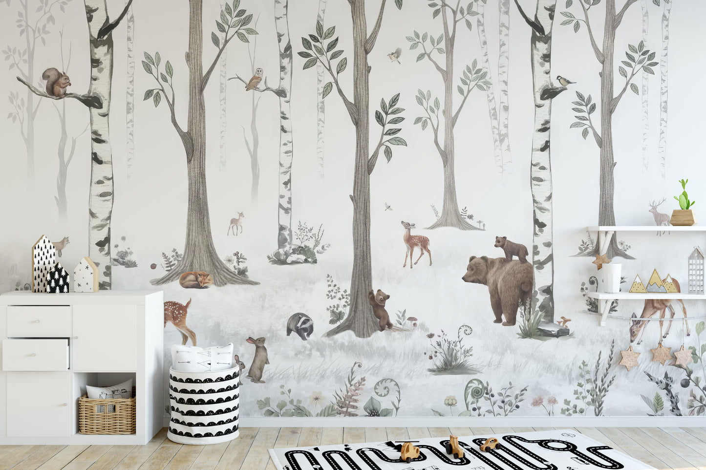 Forest Haven wallpaper mural of woodland animals in birch trees behind a white dresser and shelves in a kids room